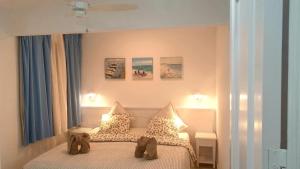 a bedroom with a bed with two teddy bears on it at Holamigos Morro Jable in Morro del Jable +51 photos