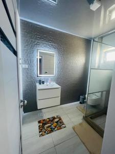 a bathroom with a sink and a mirror at Vila LaDom Etajul 1 in Mamaia Sat/Năvodari +22 photos