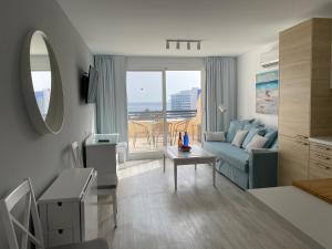 a living room with a couch and a table at Holamigos Morro Jable in Morro del Jable