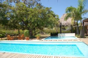 a swimming pool with a gazebo in a yard at Casa Almendra in Tamarindo