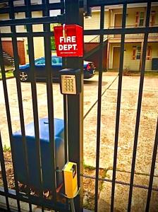 a fire deposit machine next to a fence at Trinity One Apartments - Tranquility Luxury in Jackson