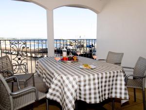 a table with a plate of food on a balcony at Residence Farenc vue sur la lagune in Marseillan