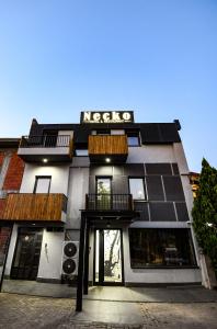 a black and white building with a sign on it at Hotel Necko in Štip
