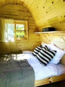 a bedroom with a bed in a wooden cabin at Egn Boutique Hotel in Stege