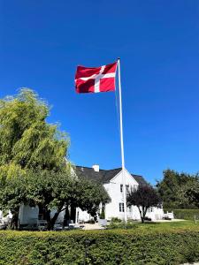 a flag on a pole in front of a house at Egn Boutique Hotel in Stege