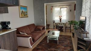 a living room with a couch and a table at Акротирия Фешева in Nesebar