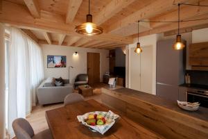 a living room with a table with a bowl of fruit on it at Chalet del Capriolo in Vodo Cadore