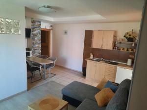 a living room and kitchen with a couch and a table at Apartman U Adamov in Liptovský Mikuláš