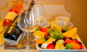 a plate of fruit and wine glasses on a table at Orient Express & Spa by Orka Hotels in Istanbul