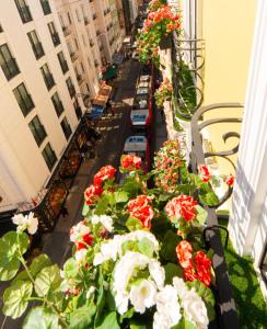 a balcony with red and white flowers on a street at Orient Express & Spa by Orka Hotels in Istanbul