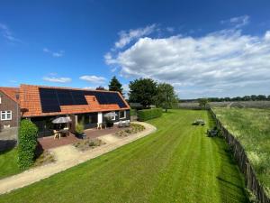 an aerial view of a house with a solar roof at Bed & Breakfast Bed in Brabant Veghel in Veghel