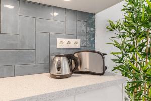 a toaster sitting on a counter in a kitchen at Tenerife Royal Gardens One Bedroom Apartment in Playa de las Americas