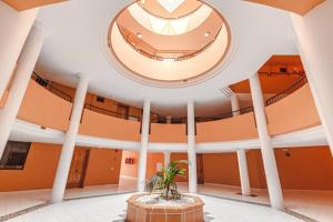 a large building with a ceiling with a plant in the middle at Tenerife Royal Gardens One Bedroom Apartment in Playa de las Americas