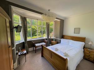 a bedroom with a bed and a large window at The Woodlands in Sandsend
