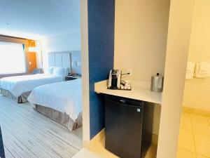 a hotel room with two beds and a counter with a coffee maker at Holiday Inn Express & Suites - Phoenix - Airport North, an IHG Hotel in Phoenix