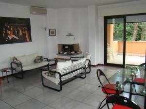 a living room filled with furniture and a fireplace at Appartamento Sirolo in Sirolo