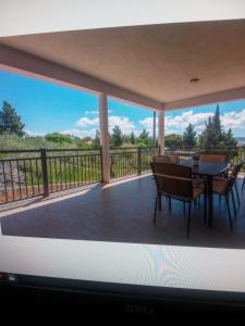 a view of a balcony with a table and chairs at Apartment Plitvice in Starigrad-Paklenica