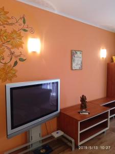 a living room with a large flat screen tv at Апартамент Златна дюна-Фешева in Nesebar