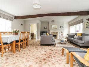 a living room with a table and chairs and a couch at Grange House in Skipton