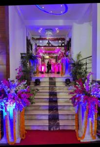a set of stairs with purple and purple flowers at Hotel Golden sky in Lucknow