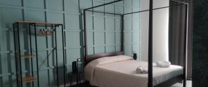 a bedroom with a bed and a glass wall at Panoramica dei Templi B&B in Agrigento