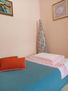a bedroom with a bed with a head board at Lux Appartamento in Busso