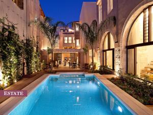 a swimming pool in the middle of a building at Rimondi Boutique Hotel - Small Luxury Hotels of the World in Rethymno