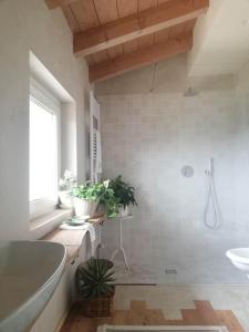 a bathroom with a tub and a toilet and a sink at B&B Cà Montemezzano in Verona