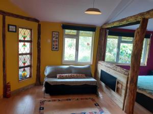 a living room with a couch and windows at Hen House in Hastings
