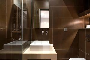 a bathroom with a sink and a toilet at Habitat Parisien - Marais Sicile in Paris +34 photos