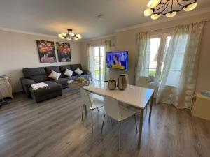 a living room with a table and a couch at SANTA ANA 8 in Maspalomas