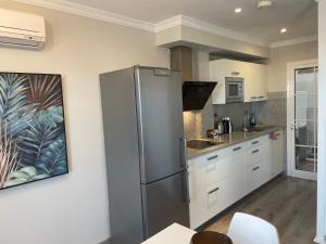 a kitchen with a stainless steel refrigerator at SANTA ANA 8 in Maspalomas