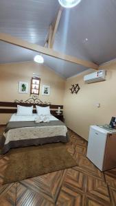 Giường trong phòng chung tại CT Vila Raiza Goulão