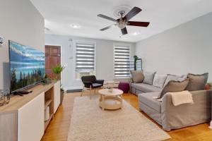 a living room with a couch and a ceiling fan at Stylish Rowhome-Fishtown-Near Shops in Philadelphia