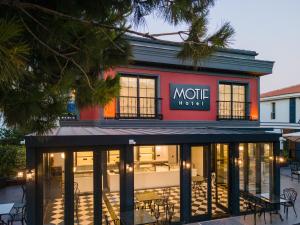a coffee shop with a sign on the front of it at Motif Hotel Çeşme in Çeşme