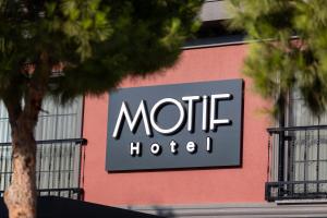 a sign for a hotel on the side of a building at Motif Hotel Çeşme in Çeşme