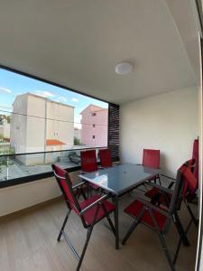 a dining room with a table and chairs and a large window at Apartment Lida in Podstrana