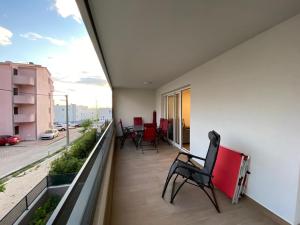 a balcony with chairs and a view of a street at Apartment Lida in Podstrana
