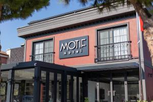 a store front with a sign that reads motive at Motif Hotel Çeşme in Çeşme