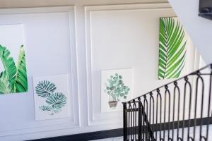 a room with two windows with prints of plants at Motif Hotel Çeşme in Çeşme
