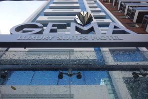 a sign for a luxury suites hotel on top of a building at Hotel Gema Luxury Suites in Montevideo