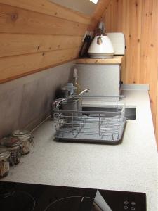 a kitchen with a dish drying rack on a counter at Harlosh Hideaways - Stargazer Pod in Harlosh