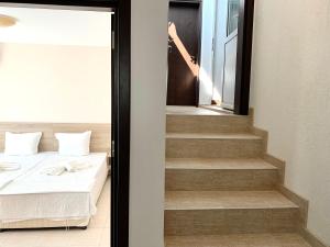 a bedroom with a bed and a woman in a mirror at Byala Residence Apartments in Byala