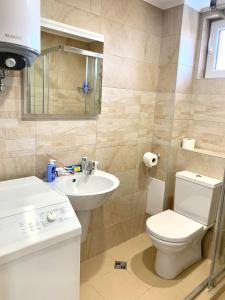 a bathroom with a toilet and a sink at Byala Residence Apartments in Byala