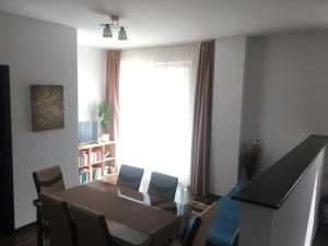 a dining room with a table and chairs and a window at Home sweet home in Cluj-Napoca
