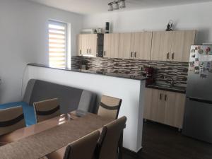 a kitchen with a table and chairs and a refrigerator at Home sweet home in Cluj-Napoca