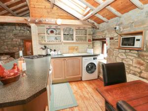 a kitchen with a stove and a stove top oven at The Granary in Morpeth