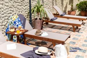 a row of tables and chairs with hats on them at Motif Hotel Çeşme in Çeşme