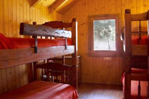 a room with several bunk beds in a cabin at Xalet De Prades in Prades
