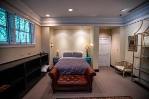 a bedroom with a bed and a couch and a window at Washington Street Quarters in Lewisburg